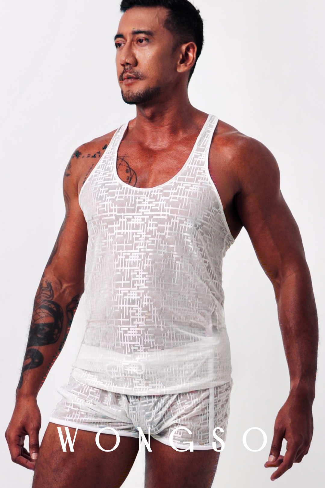 Back View: Back view of men’s sheer muscle tank in silver white with lightweight woven fabric – Libertine Collection