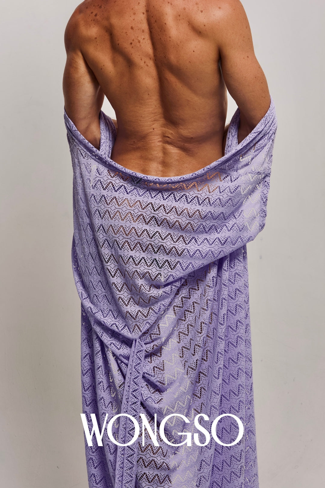 Close-up back view of a male model wrapping the WONGSO Lilac Sleeveless Kimono