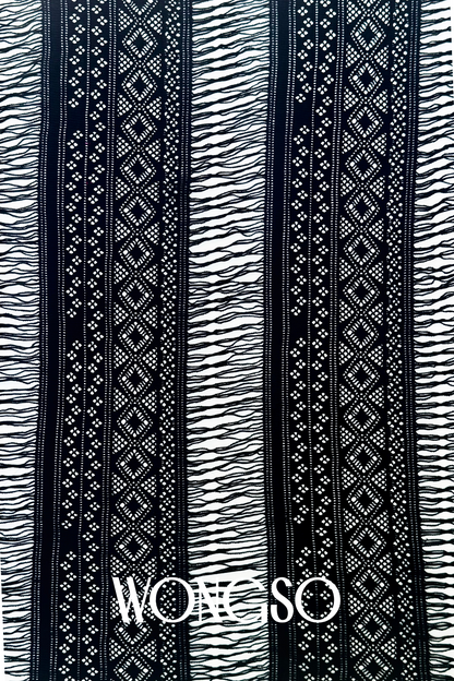Close-up of black fringe detailing on men's sarong wrap