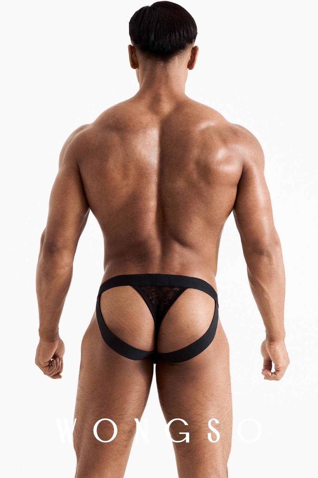 Full body back view of the WONGSO leopard print lace jockstrap thong on a male model. Men's festival intimates.