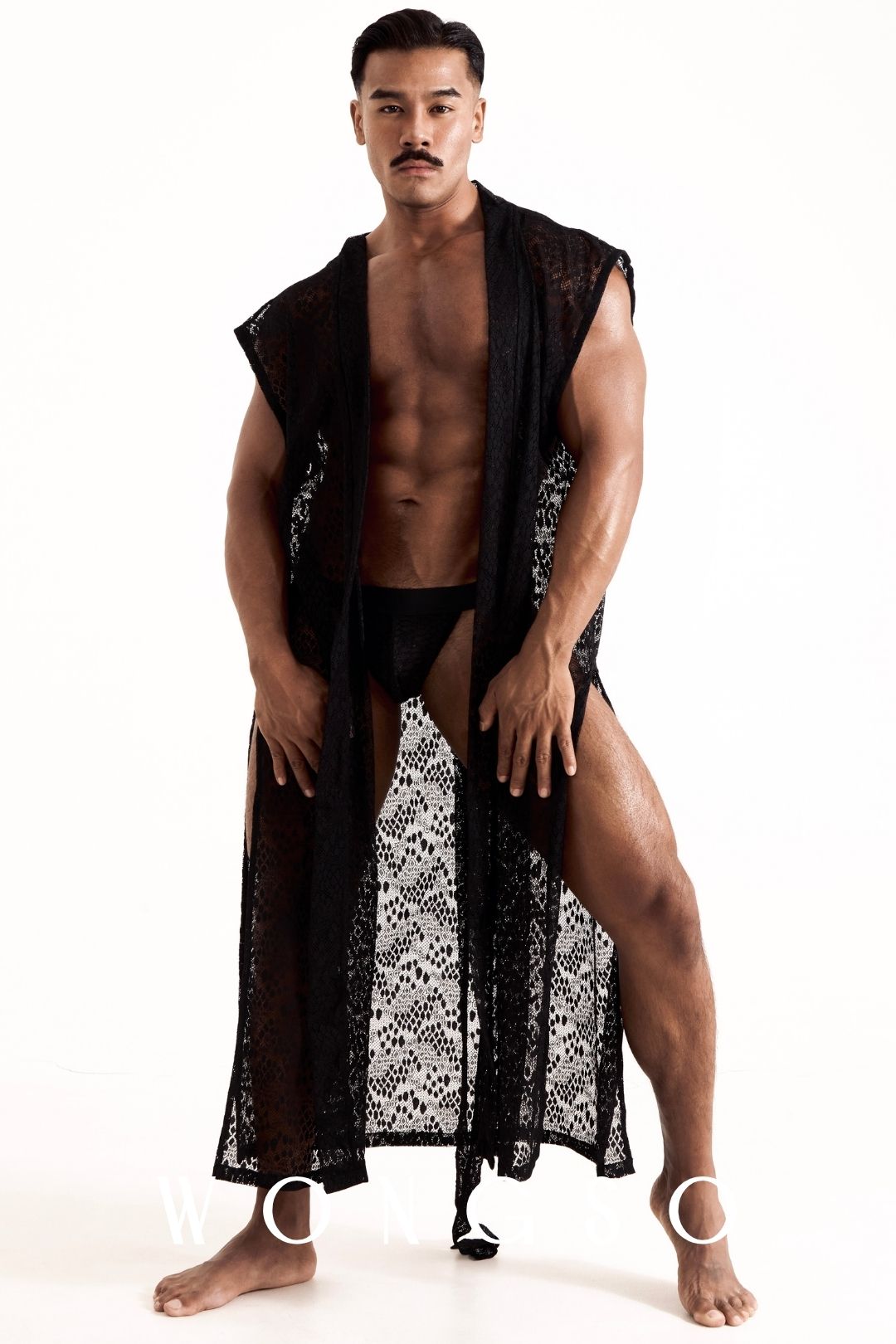 Close-up front view of the leopard print lace kimono worn open on a male torso, showing the lace texture and construction. Men's sheer lace kimono by WONGSO.