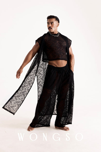 Full outfit shot of a male model wearing the WONGSO Coven collection - leopard print lace kimono, crop top, wide leg trousers and chain necklace. Men's queer festival fashion.