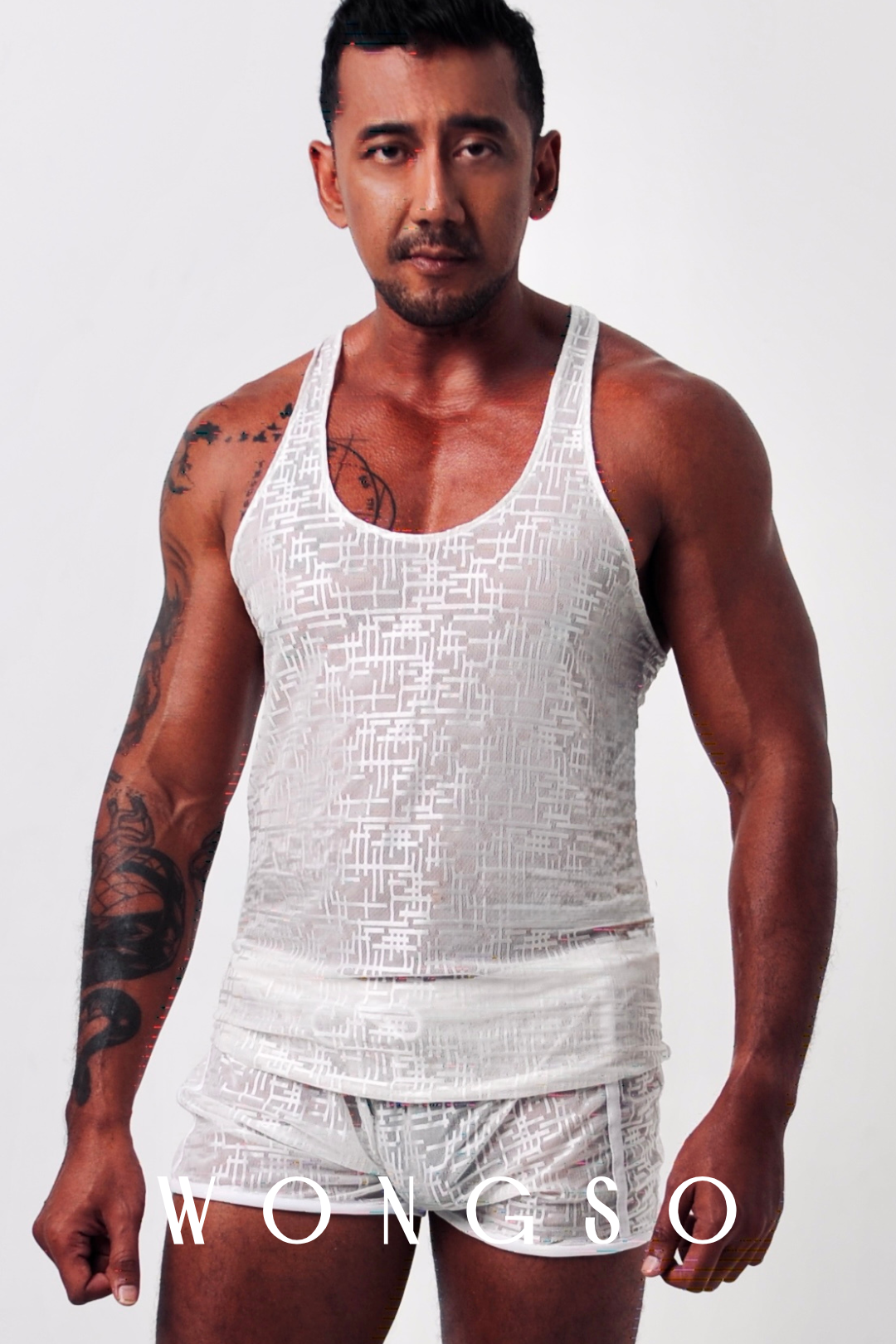 Front View: Sheer muscle tank in silver white showcasing woven silver-thread texture – Libertine Collection