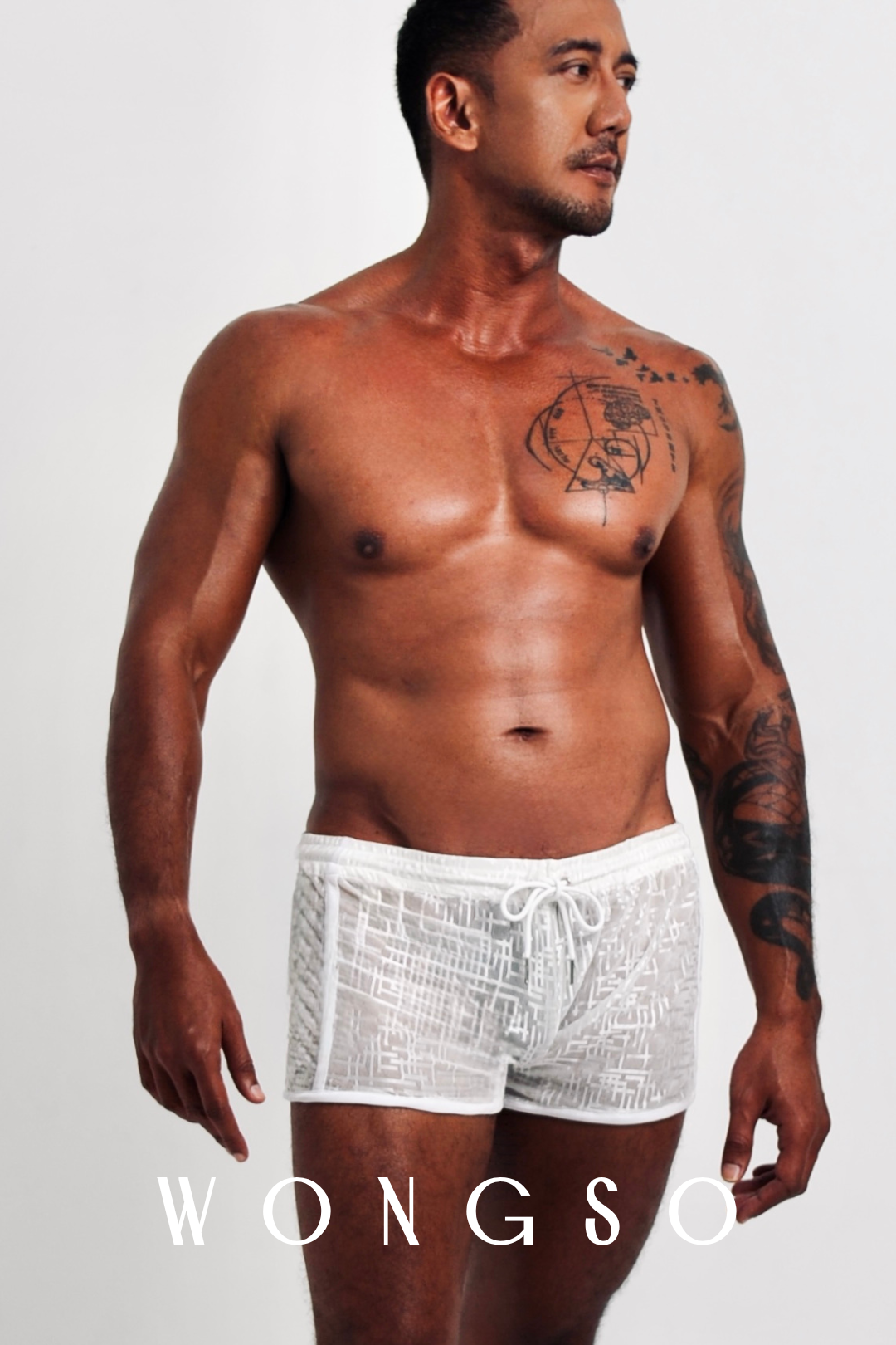 Front View: Men’s sheer slut shorts in silver white with silver-thread detail – Libertine Collection