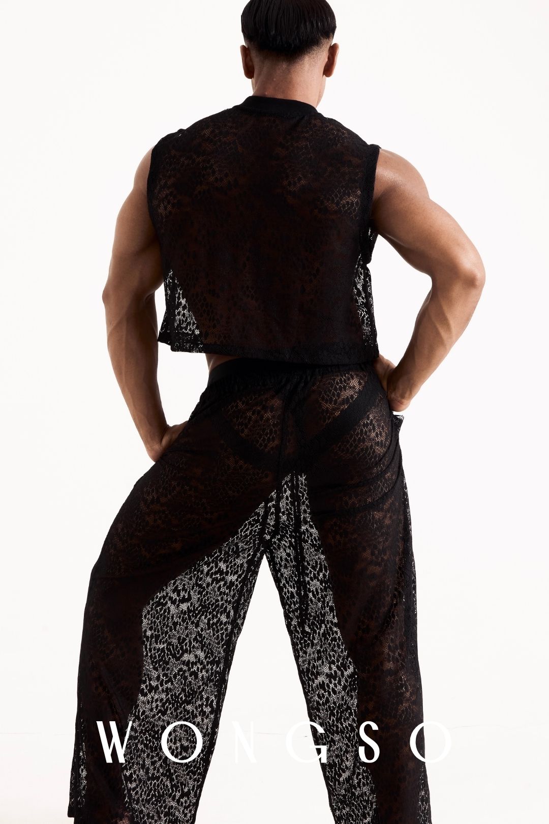 Full body back view of the Libertine crop lace top in Leopard Black on a male model. Men's boxy cropped festival top.
