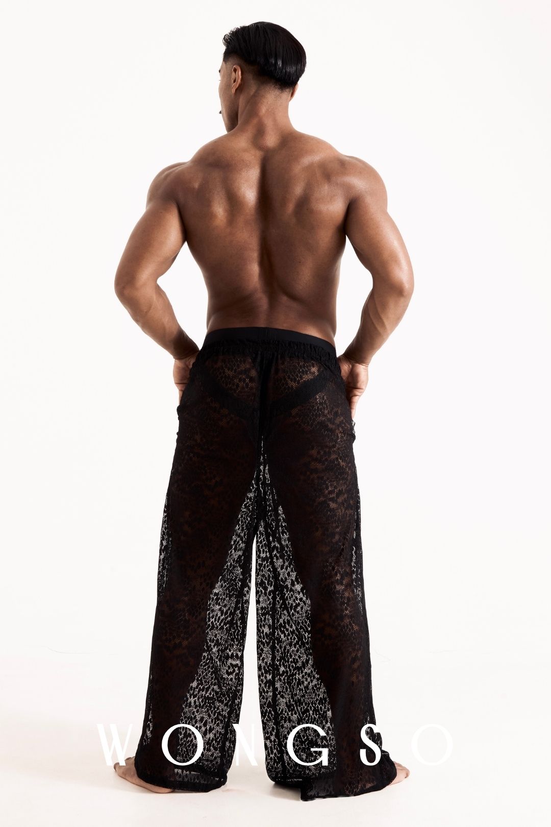 Full body back view of the WONGSO leopard print lace wide-leg trousers, showing the billowing drape. Men's statement festival trousers.