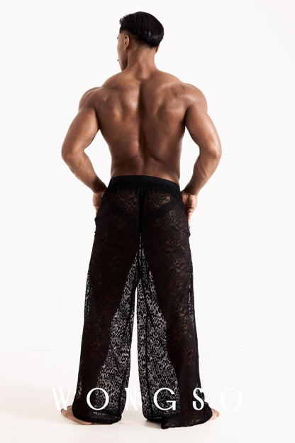 Full body back view of the WONGSO leopard print lace wide-leg trousers, showing the billowing drape. Men's statement festival trousers.