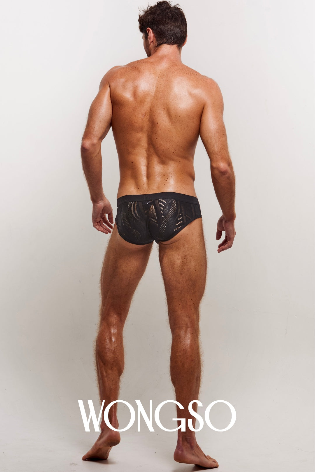 Male model wearing the WONGSO black lace batik briefs