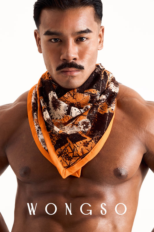 Close-up of a male model wearing the WONGSO sheer orange floral festival bandana