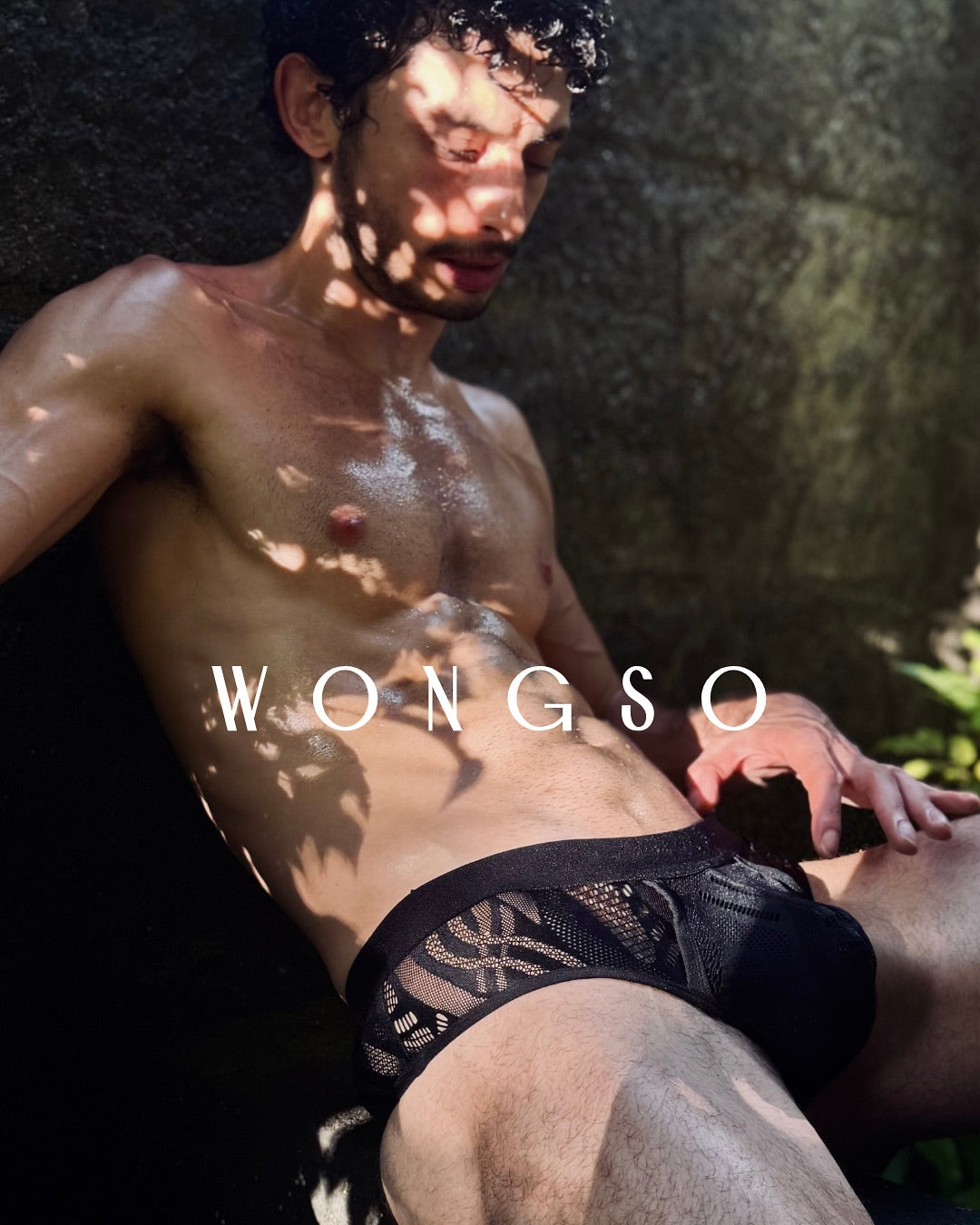 Model in the Black Batik lace thong in dappled garden light