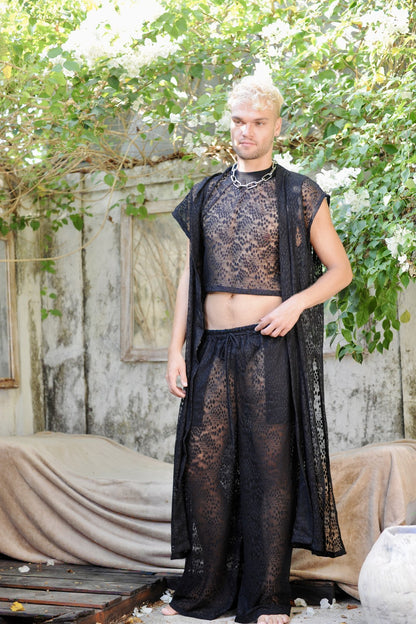 Model in the full Coven look in a garden courtyard