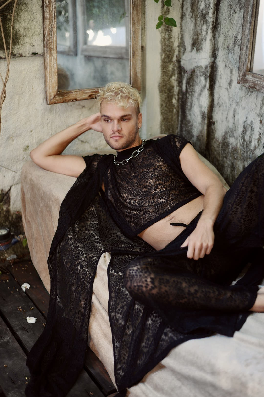 Model in the Libertine leopard lace kimono reclining in a garden courtyard