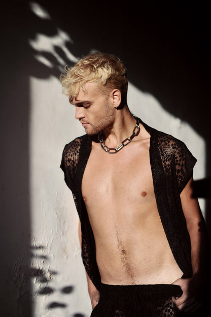 Model in the leopard lace kimono worn open with the chain necklace, in hard window light