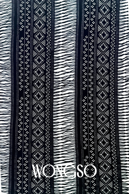 Close-up of the black fringe detailing on WONGSO's men's sarong wrap
