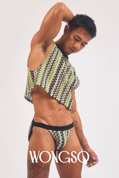 Queer model in the WONGSO green knit crop top with arms raised