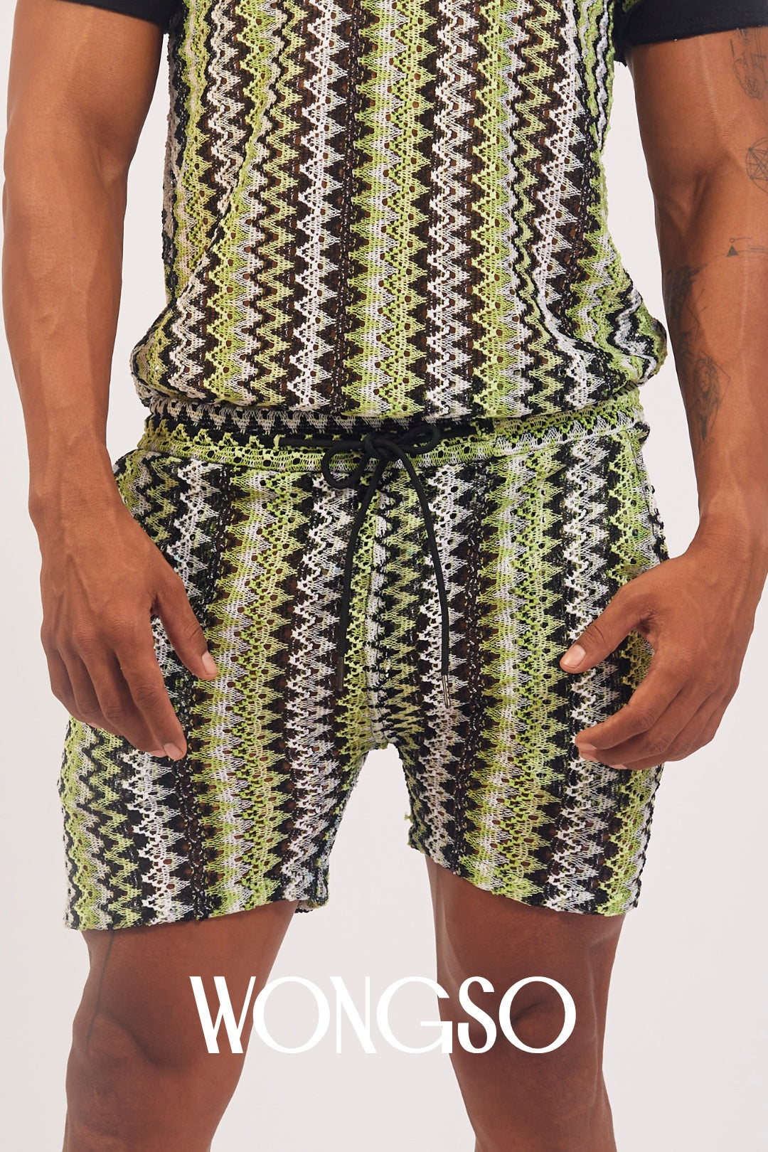 Model styling WONGSO Green Knit Shorts with a matching green polo shirt