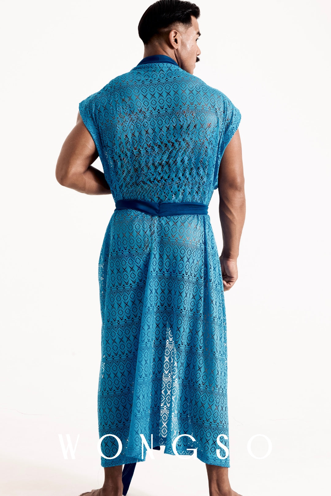 Full body back view of the WONGSO Boheme Sheer Lace Kimono in Bali Blue on a male model, the sweeping oversized drape showcasing sheer blue lace