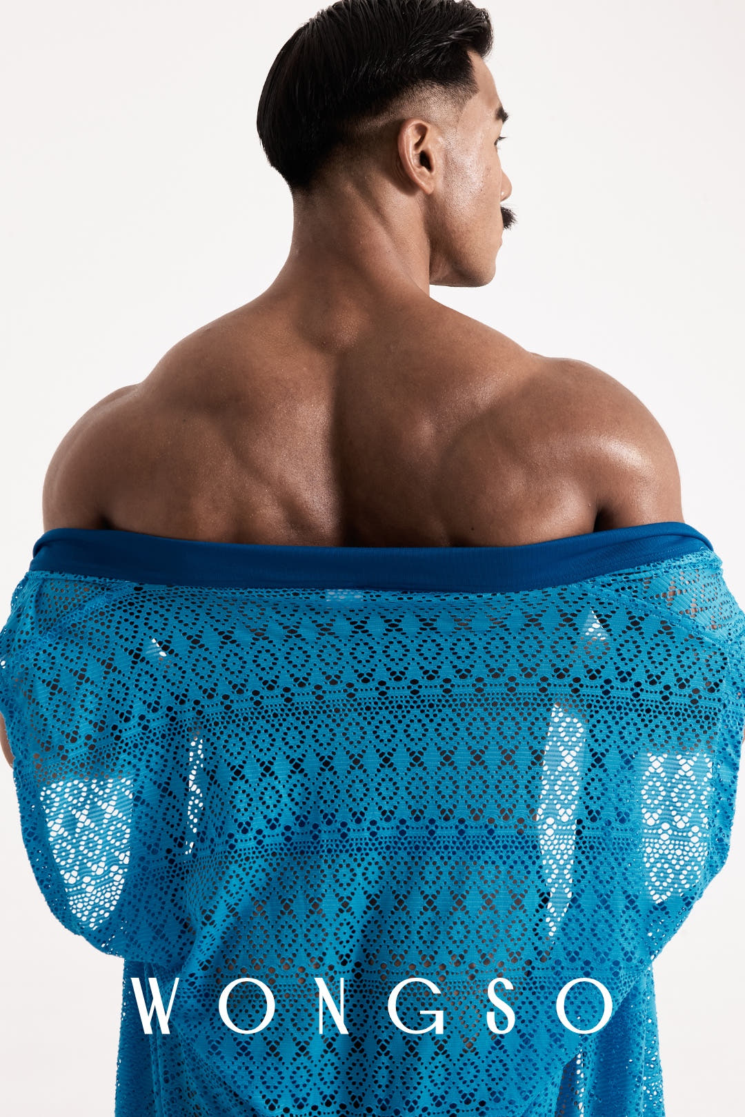 Close-up back view of the sheer blue lace WONGSO kimono styled off the shoulder, showing the geometric lace pattern