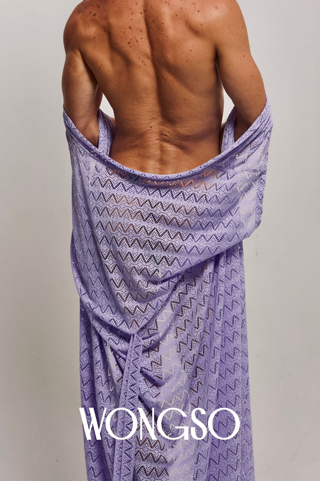 Close-up back view of a male model wrapping the WONGSO Lilac Sleeveless Kimono