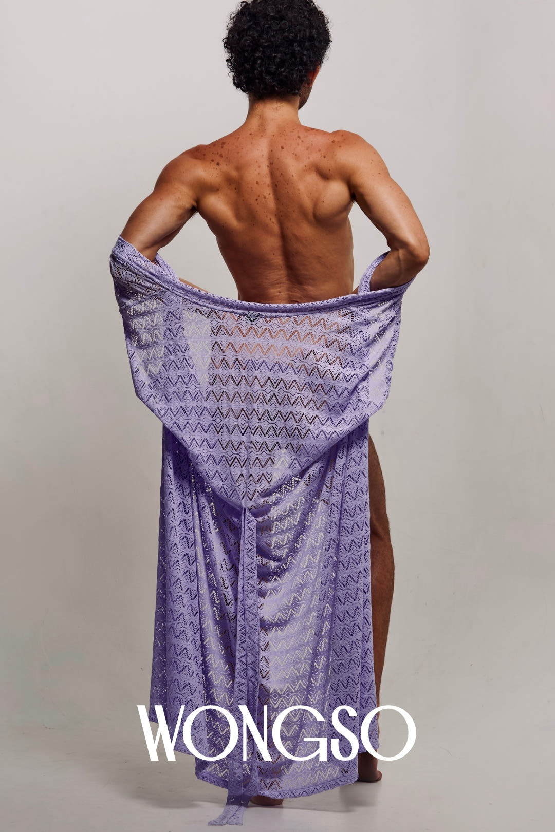 Front view of a male model with arms raised, wearing the WONGSO Lilac Sleeveless Kimono