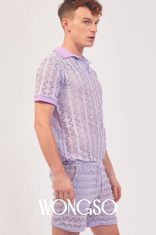 Queer man wearing the WONGSO Lilac Lace Polo Shirt styled with festival shorts