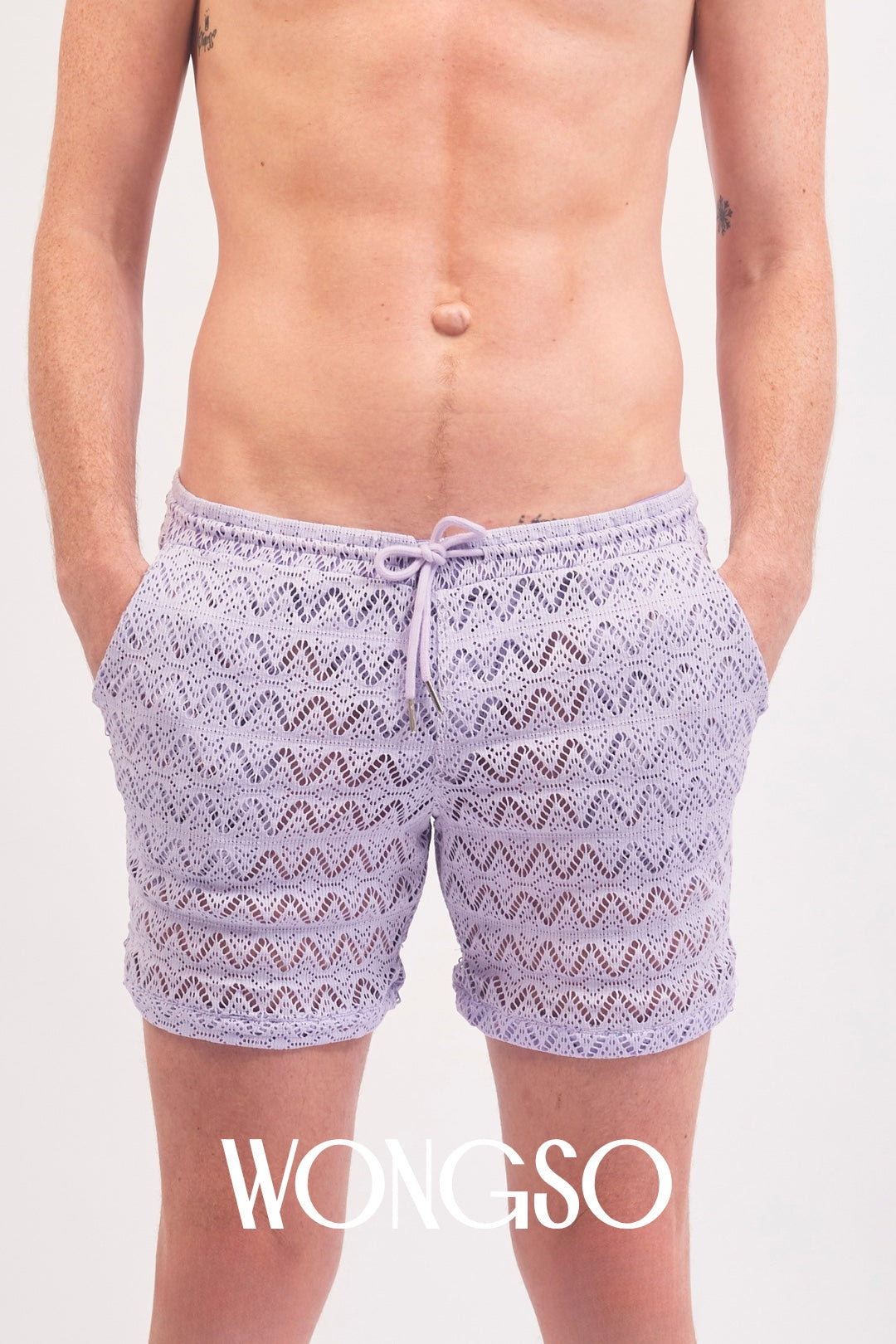 Close-up front view of the sheer lilac lace texture on WONGSO's festival shorts