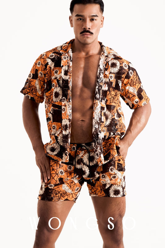 Close-up of the WONGSO men's sheer orange floral camp collar shirt showcasing the translucent fabric and tonal buttons