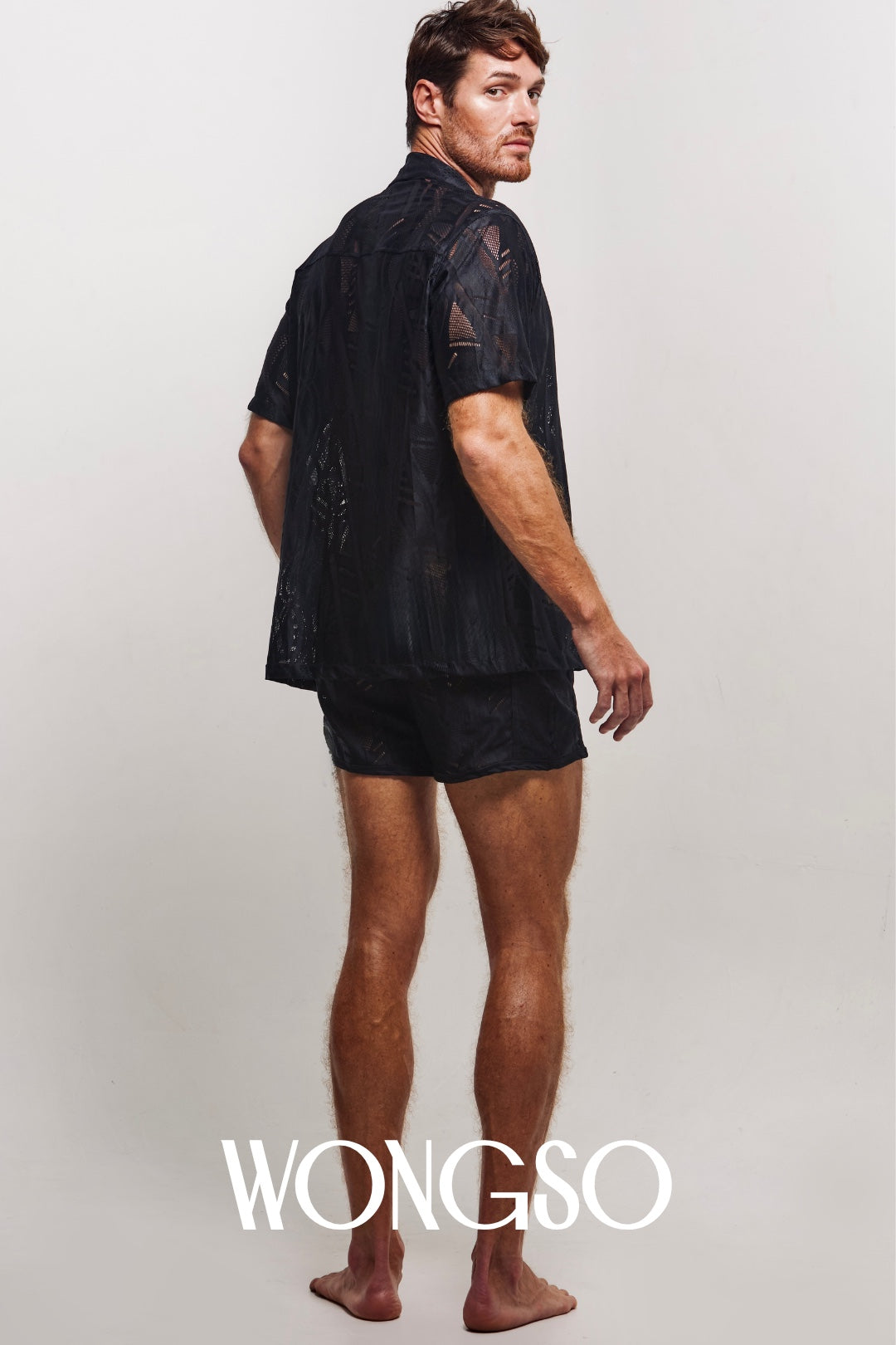 Model wearing WONGSO's men's relaxed fit shirt with traditional batik print