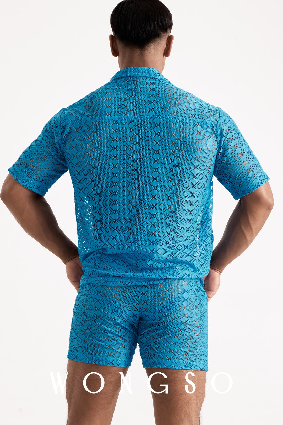 Full body back view of the WONGSO Boheme Sheer Lace Relaxed Shirt in Bali Blue on a male model, showing the tailored yet unrestrictive fit of the sheer blue lace