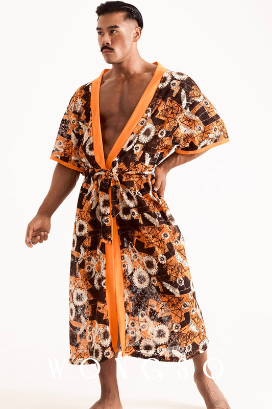 Full body shot of a man wearing WONGSO's sheer orange floral kimono with orange trim