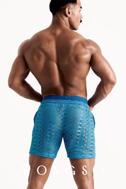 Full body back view of the WONGSO Boheme Sheer Lace Shorts in Bali Blue on a male model, the tailored mid-thigh fit highlighting the legs and geometric lace