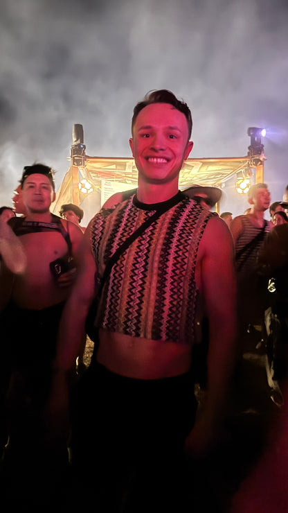 Festivalgoer wearing the WONGSO Green Knitted Crop Top in a crowd under pink stage light