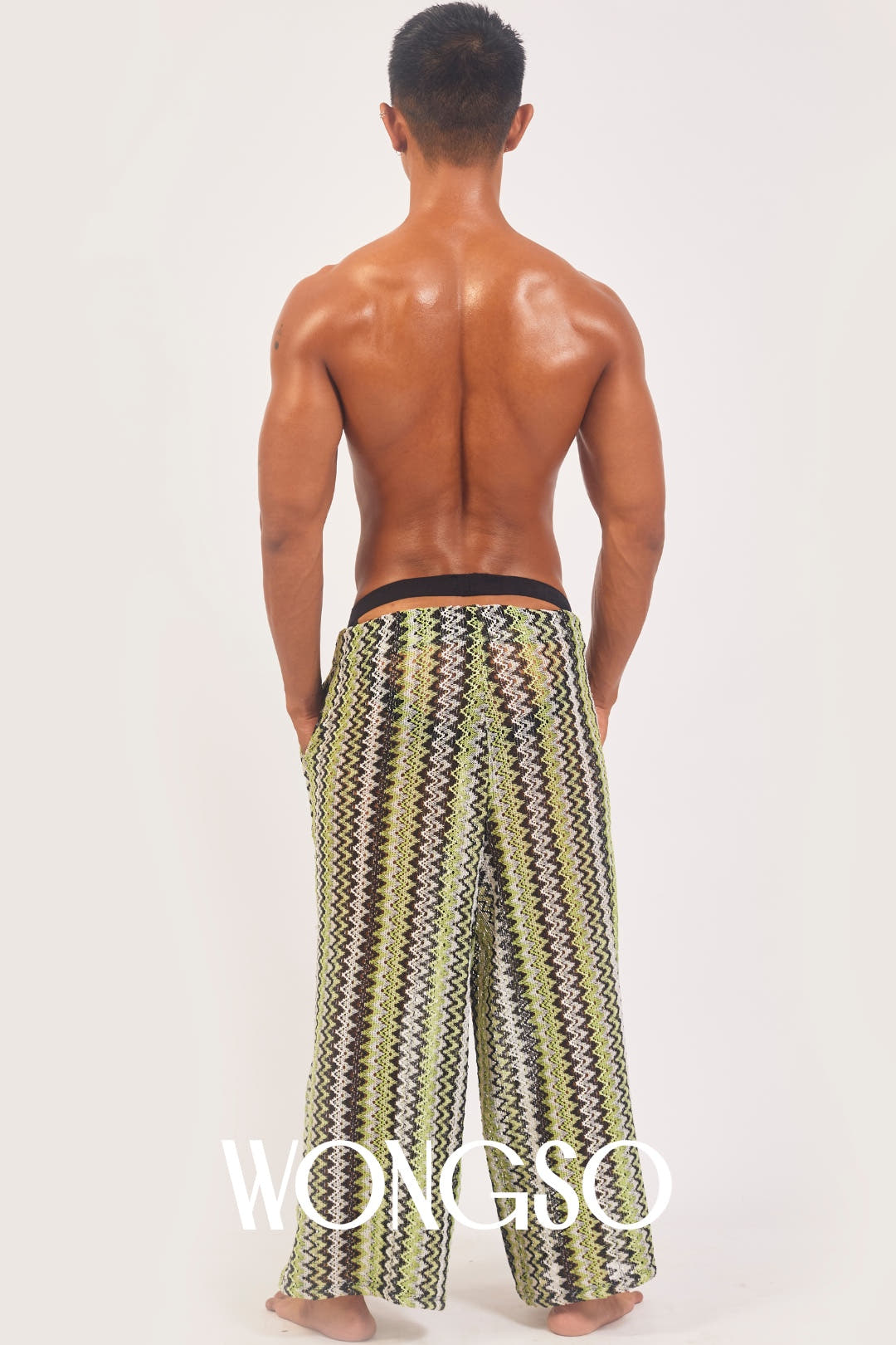 Back view of the WONGSO green knit wide leg pants on a male model